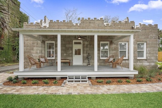 back of property featuring covered porch