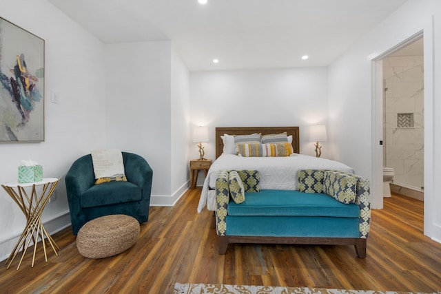 bedroom featuring dark wood-type flooring and ensuite bathroom