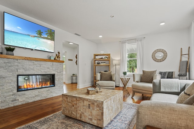 living room with hardwood / wood-style flooring and a fireplace