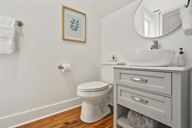 bathroom with lofted ceiling, vanity, toilet, and hardwood / wood-style floors