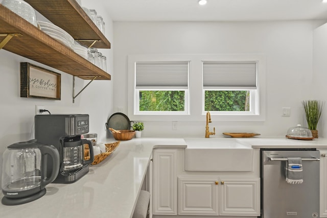 kitchen with white cabinetry, dishwasher, and sink