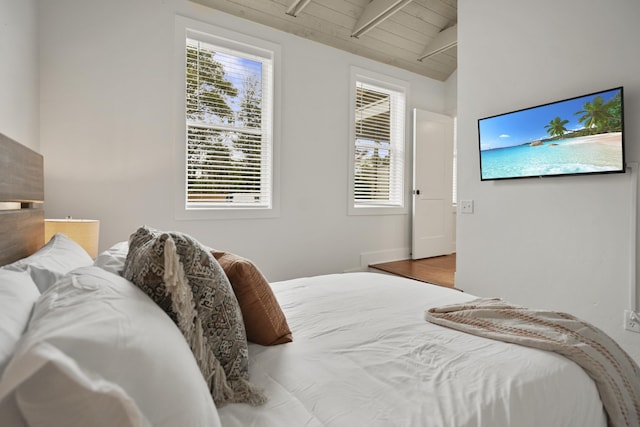 bedroom with wood-type flooring, vaulted ceiling with beams, and wood ceiling