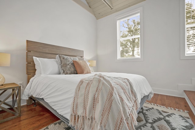 bedroom with hardwood / wood-style flooring and vaulted ceiling