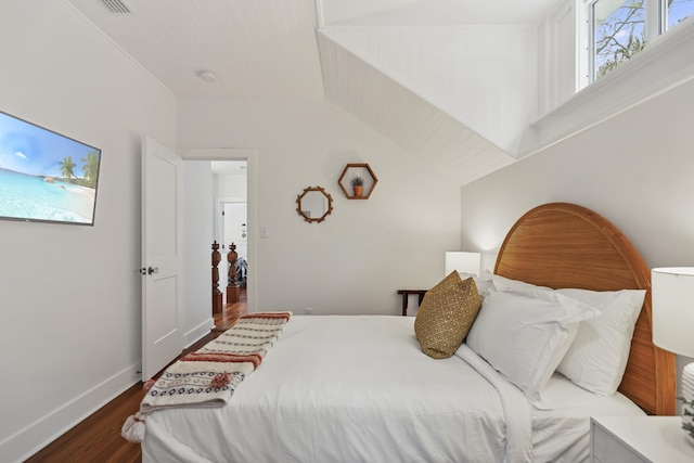 bedroom featuring dark hardwood / wood-style flooring and vaulted ceiling