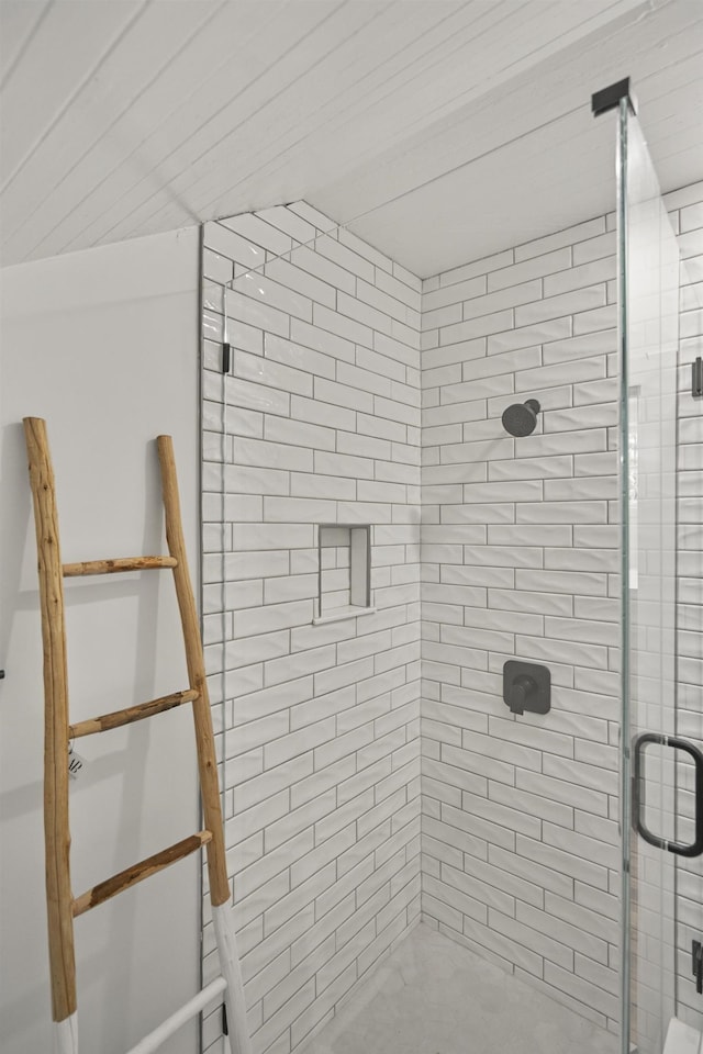 bathroom featuring a shower with door