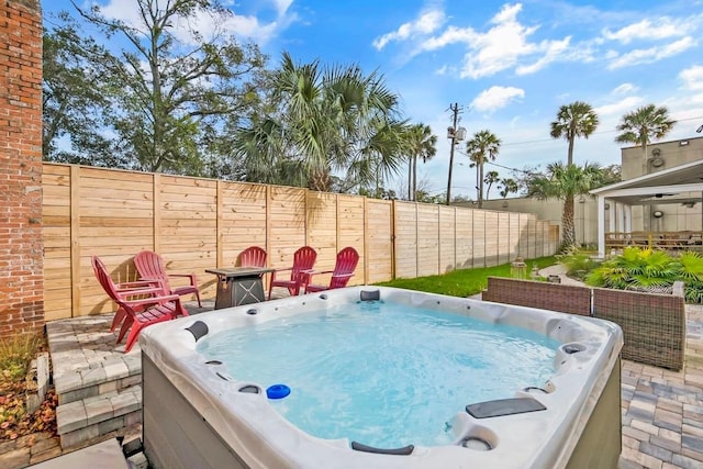 view of swimming pool featuring a hot tub