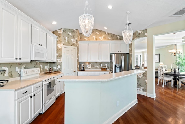 kitchen with white appliances, white cabinetry, light countertops, and pendant lighting