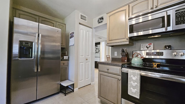 21 Mid Pines Cir Unit 21, Palm Coast, FL 32137 - kitchen with appliances with stainless steel finishes, light tile patterned flooring, and dark countertops