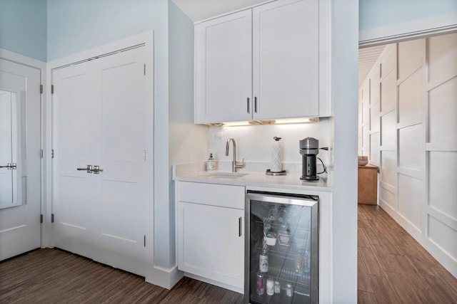 bar featuring wine cooler, a sink, and wood finished floors