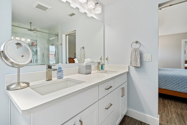 ensuite bathroom with visible vents, a sink, and ensuite bath