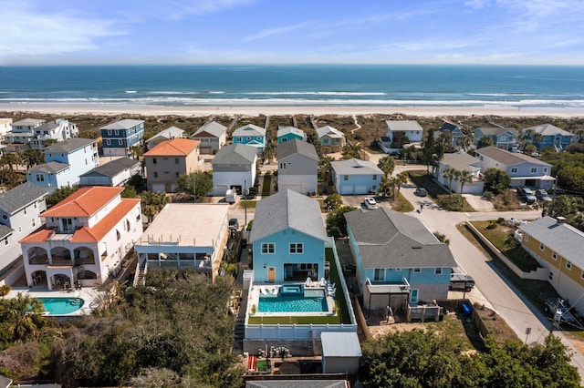 drone / aerial view featuring a view of the beach and a residential view