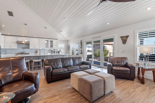 living room with light wood-style floors, wooden ceiling, visible vents, and vaulted ceiling