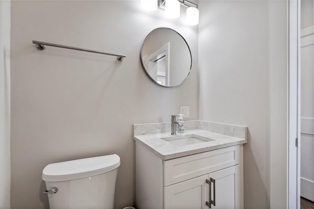 bathroom with toilet and vanity