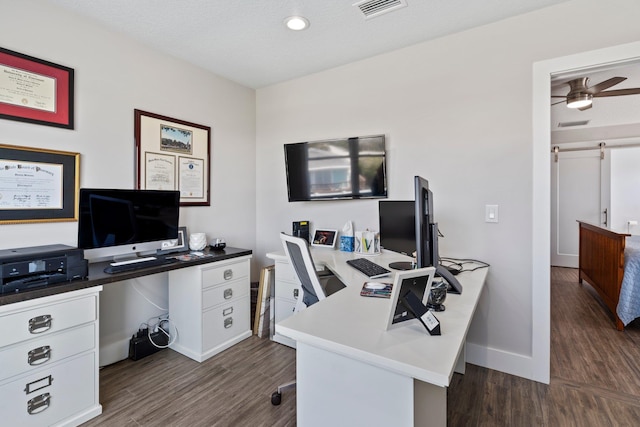 office featuring a ceiling fan, baseboards, visible vents, and dark wood-type flooring