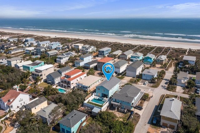 drone / aerial view with a water view, a residential view, and a view of the beach