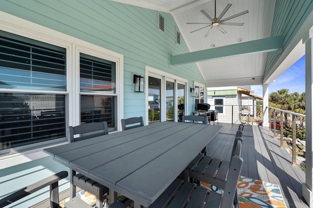 wooden deck with outdoor dining space and ceiling fan