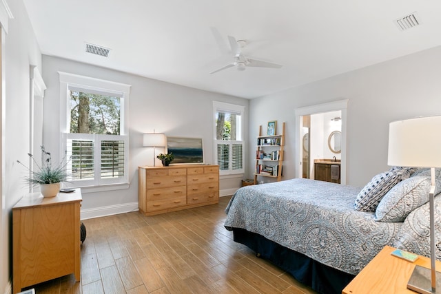 bedroom with visible vents, ceiling fan, baseboards, and wood finished floors