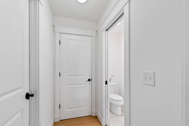 bathroom featuring wood finished floors and toilet