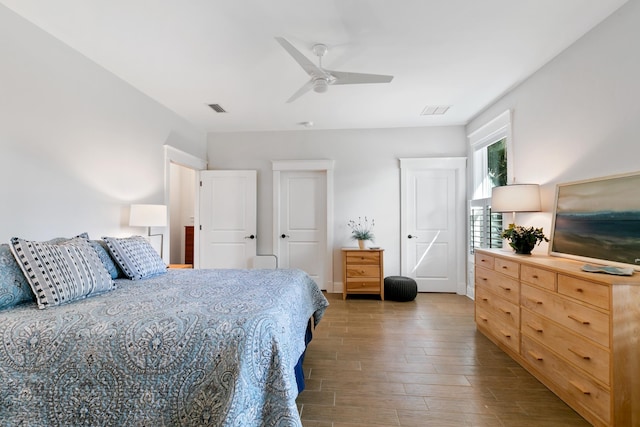 bedroom with dark wood-type flooring, visible vents, and a ceiling fan