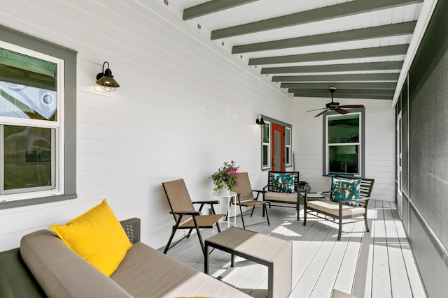 wooden deck with a porch, outdoor lounge area, and a ceiling fan