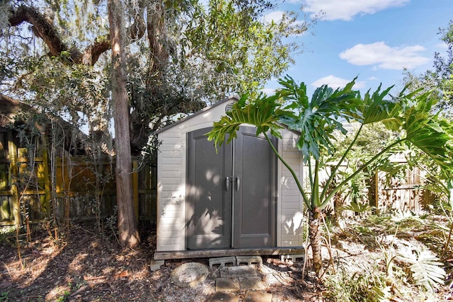 view of shed with fence