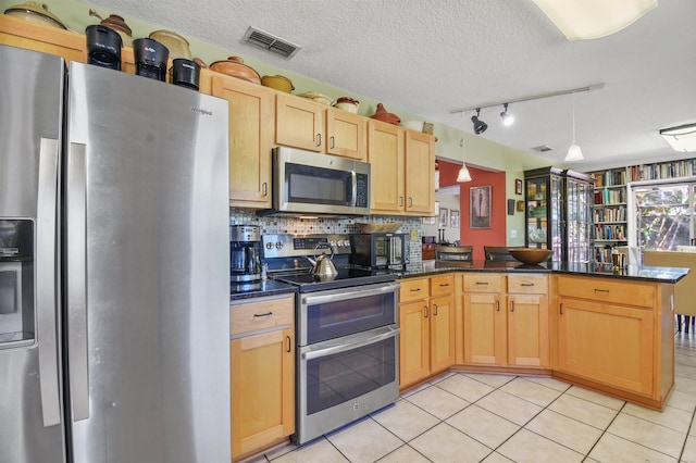 kitchen featuring visible vents, appliances with stainless steel finishes, light tile patterned flooring, a textured ceiling, and a peninsula