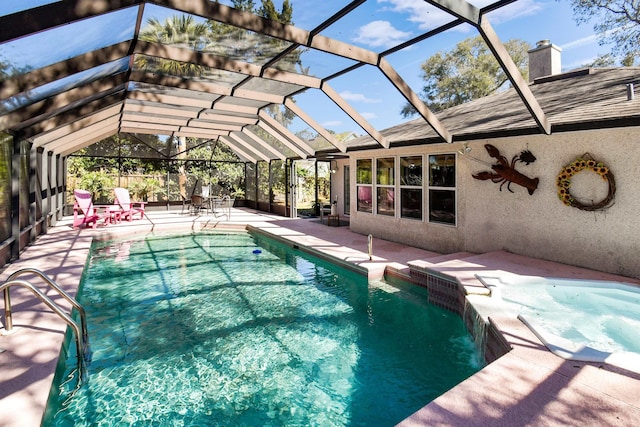 view of pool with a lanai, a pool with connected hot tub, and a patio