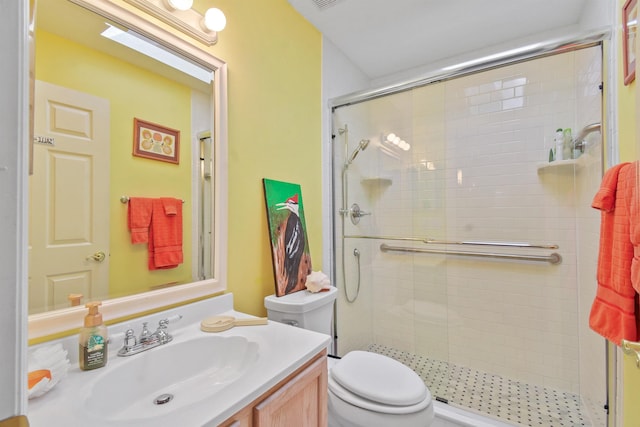 bathroom with a stall shower, visible vents, vanity, and toilet