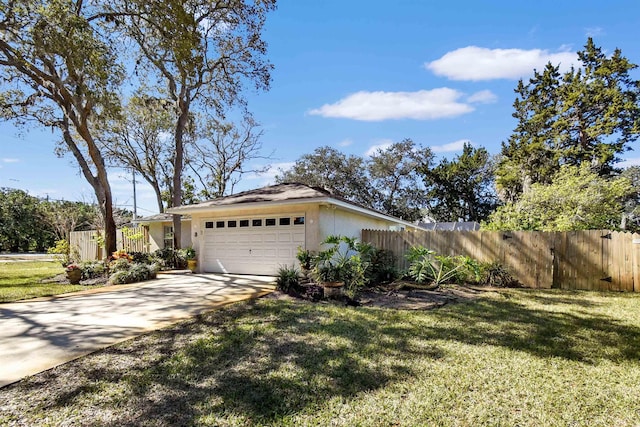 view of property exterior with a garage, concrete driveway, fence, and a lawn