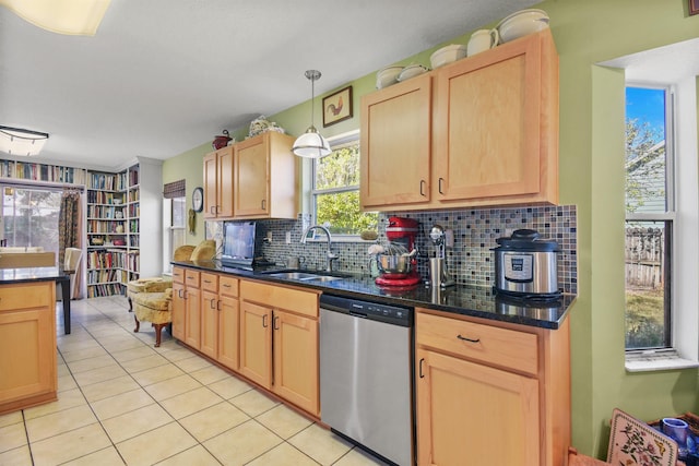 kitchen with light tile patterned flooring, a sink, stainless steel dishwasher, tasteful backsplash, and decorative light fixtures