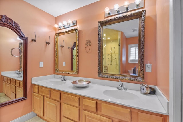 bathroom with a stall shower, a sink, and double vanity