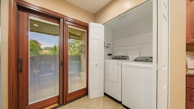 laundry room with separate washer and dryer and light tile patterned floors