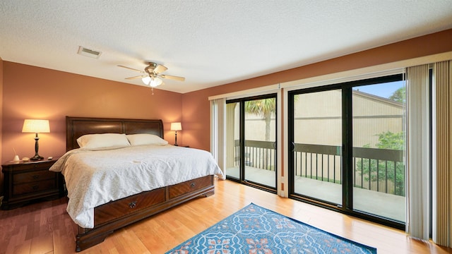 bedroom with access to exterior, ceiling fan, multiple windows, and light wood-type flooring