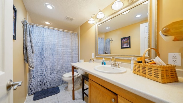 bathroom featuring tile patterned floors, vanity, a textured ceiling, toilet, and curtained shower