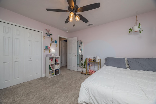 bedroom with carpet, visible vents, ceiling fan, and a closet