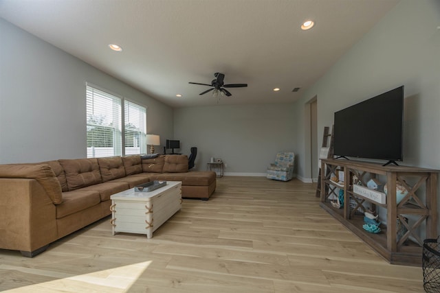 living room featuring light wood-style flooring, baseboards, ceiling fan, and recessed lighting