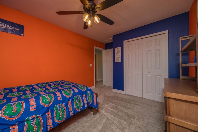 carpeted bedroom featuring a ceiling fan and a closet