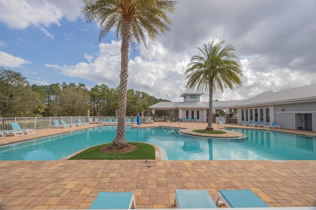 community pool featuring a patio area and fence