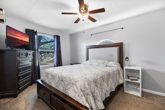 carpeted bedroom with a textured ceiling and ceiling fan