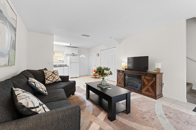 living room featuring sink and light tile patterned floors