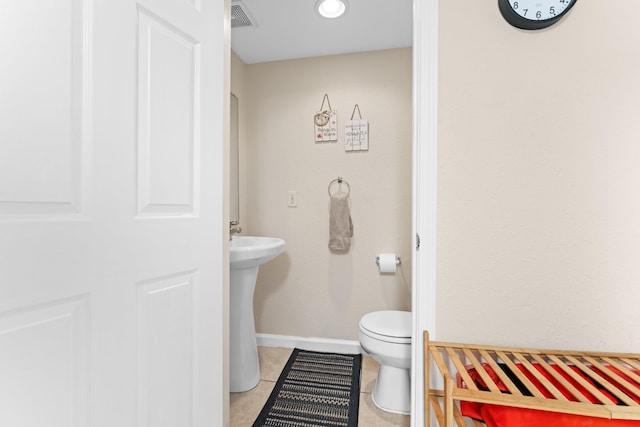 bathroom with tile patterned floors, toilet, and sink