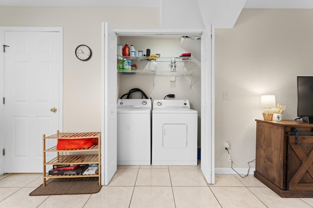 laundry area featuring light tile patterned floors and washing machine and clothes dryer