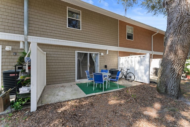 rear view of property with central AC and a patio area