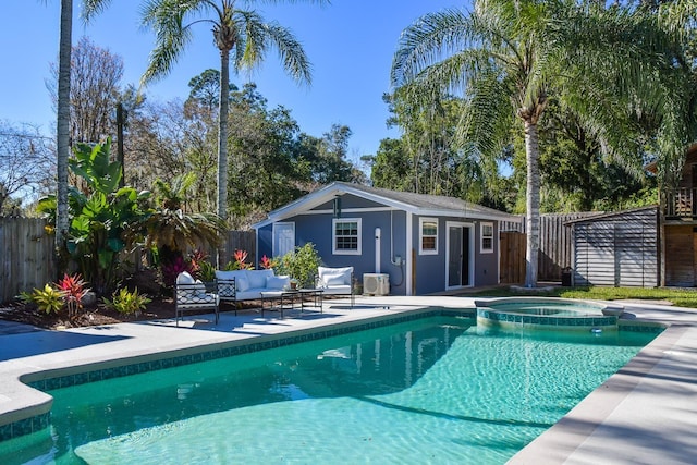 view of swimming pool with an in ground hot tub, an outdoor structure, an outdoor hangout area, and a patio