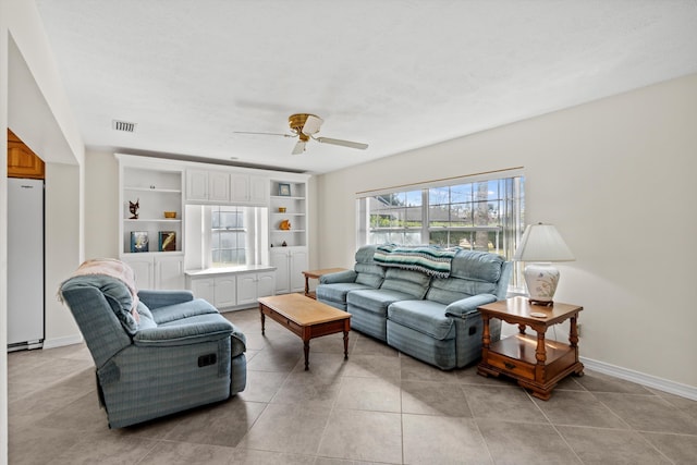 living room with light tile patterned floors and ceiling fan