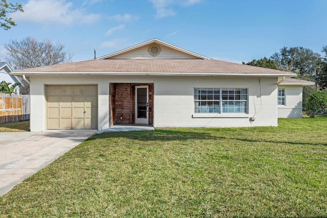 single story home featuring a garage and a front lawn