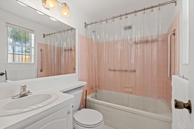 full bathroom featuring vanity, toilet, and shower / tub combo