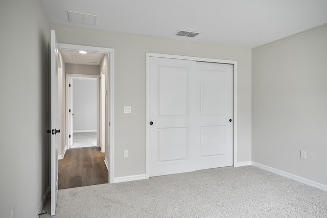 unfurnished bedroom featuring carpet and a closet