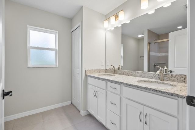 bathroom featuring a shower with door, tile patterned floors, and vanity