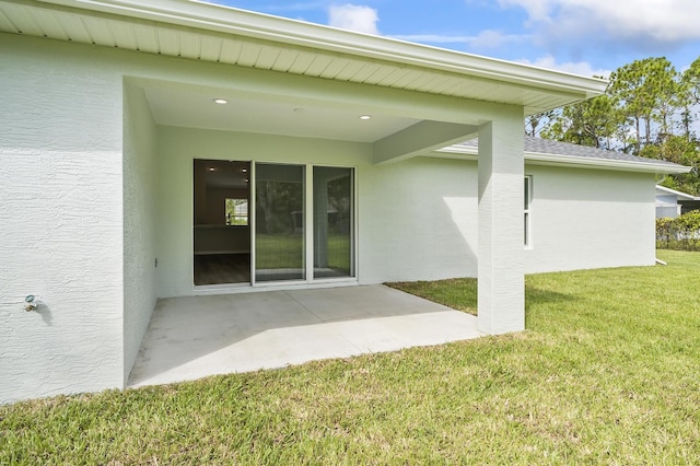 back of house featuring a yard and a patio